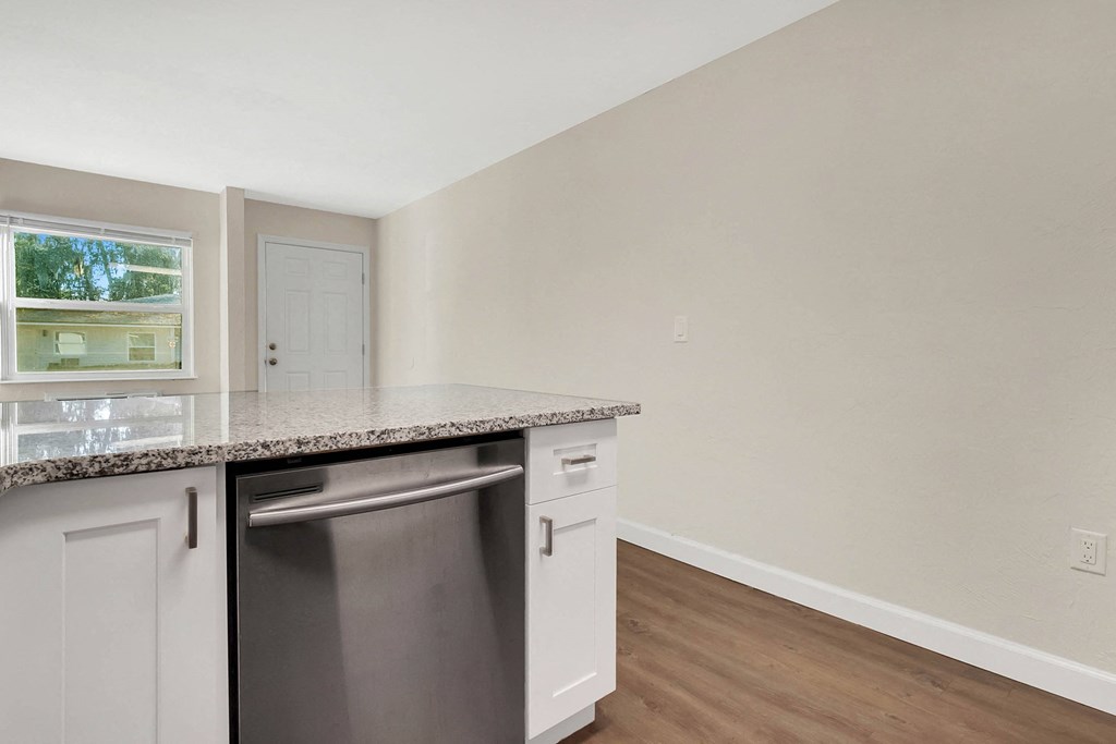 Addison Lane apartments in Gainesville, FL photo of Granite Countertopsa kitchen with an island and a dishwasher
