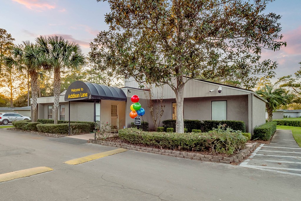 Addison Lane Apartment homes in Gainesville Florida photo of photo of a building with a black awning and balloons in front of it