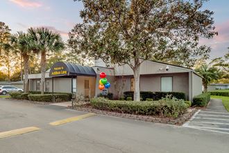 Addison Lane Apartment homes in Gainesville Florida photo of photo of a building with a black awning and balloons in front of it - Photo Gallery