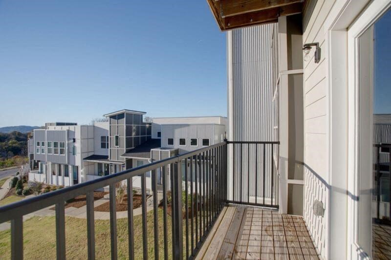 a balcony with a railing and some buildings