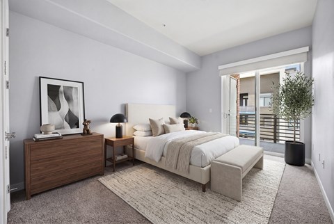A bedroom with a large bed and a wooden dresser.