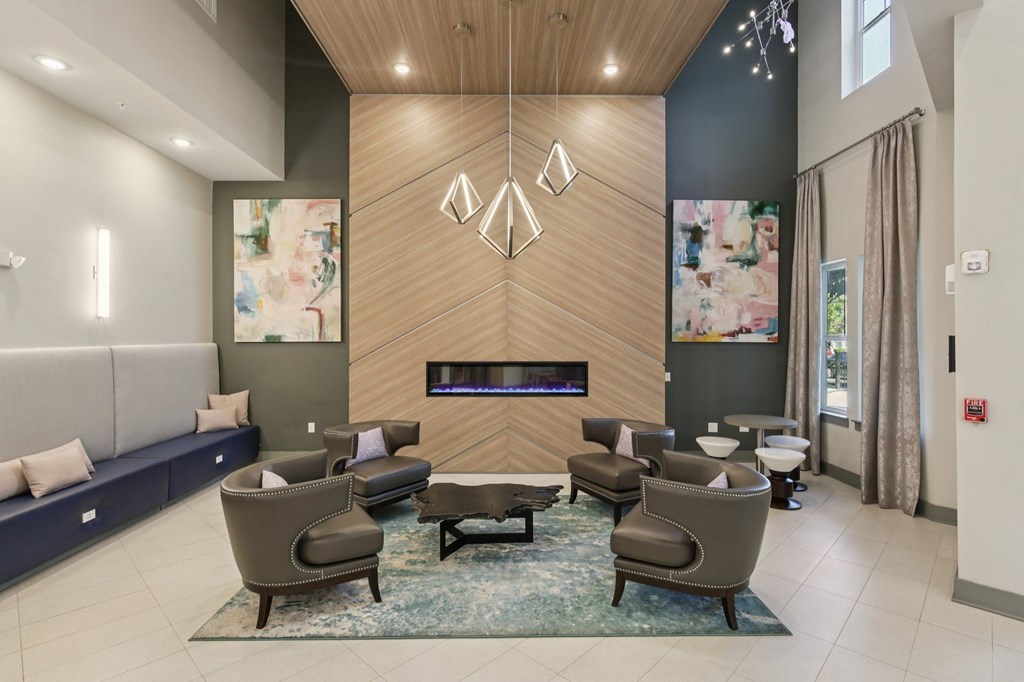 Warm and inviting clubhouse area featuring a fireplace and contemporary decor at Lotus at Starkey Ranch in Odessa, Florida.
