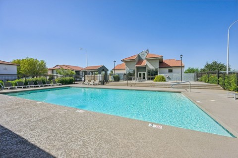 Newly Renovated Mesa, AZ, Apartments - Mesa Station Apartments - Swimming Pool With Clear Blue Water, Lounge Chairs, Fenced Sundeck, and Landscaping.