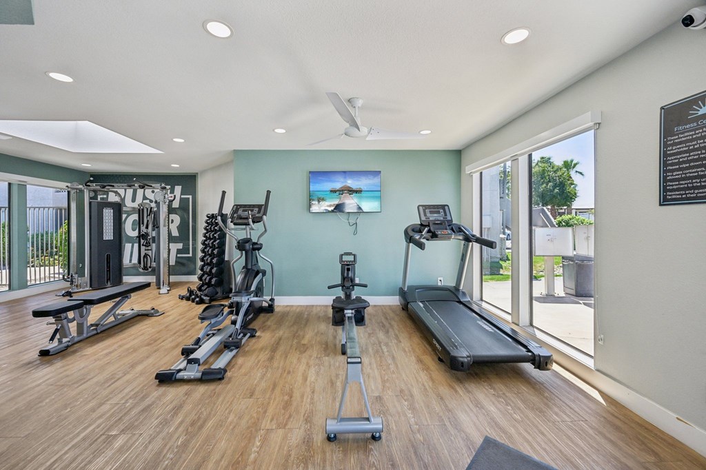 A spacious home gym with a variety of exercise equipment.