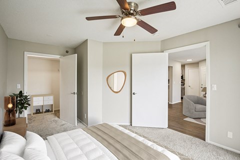A living room with a white couch and a ceiling fan.