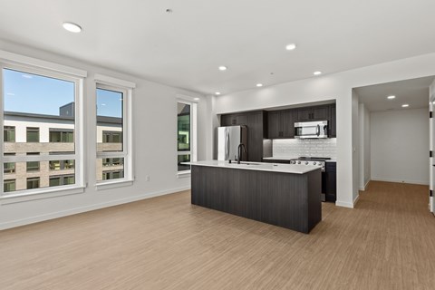 A kitchen with a counter and a fridge.