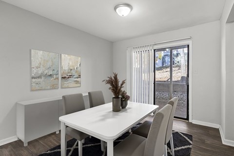 Element at 4411 Macon Apartments A dining room with a white table and chairs.