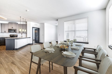 a dining room and kitchen with a table and chairs