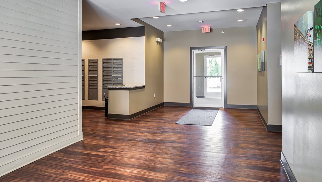 a hallway with wood floors and white walls