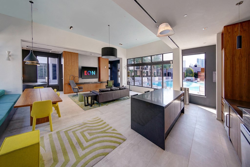 a large living room with a kitchen and a dining table