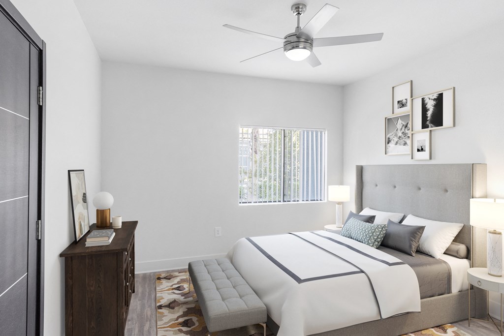 a bedroom with a large bed and a ceiling fan