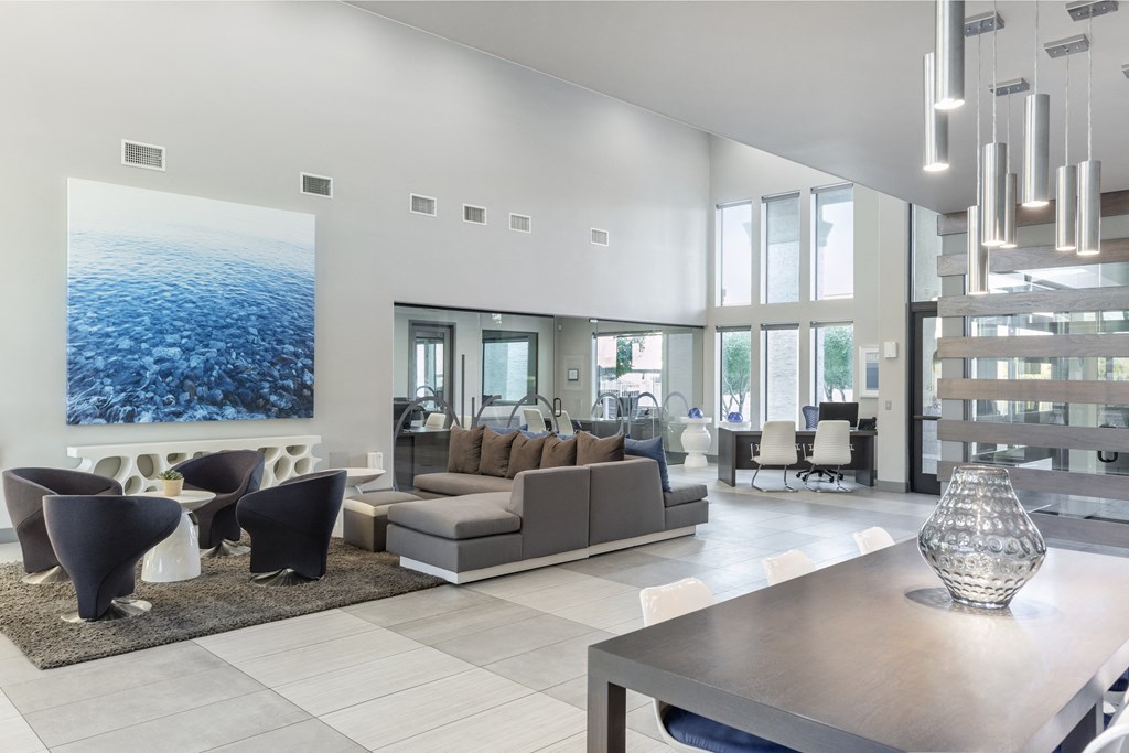 a living room with a large picture of the ocean on the wall