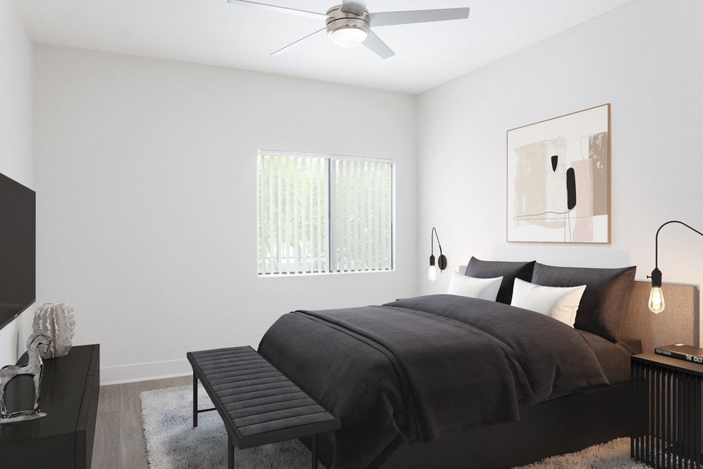 a bedroom with a large bed and a ceiling fan