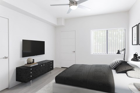 a bedroom with a bed and a tv on the wall
