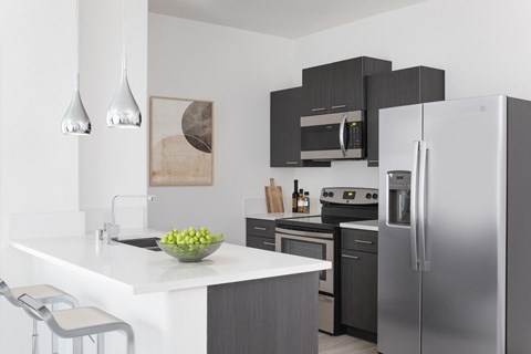 a kitchen with stainless steel appliances and a white counter top