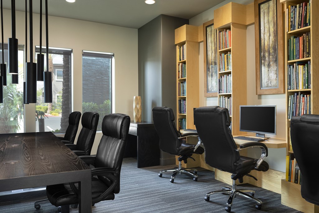 a conference room with chairs and a table and a computer