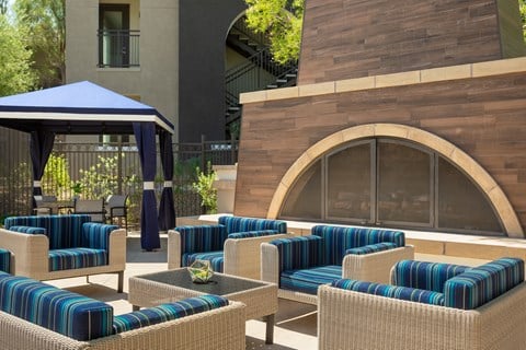 a lounge area at a resort with tables and chairs
