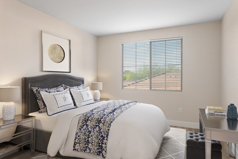 a bedroom with a large bed and a window