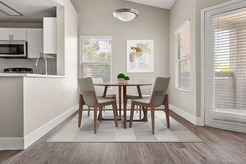A dining room with a table and chairs.
