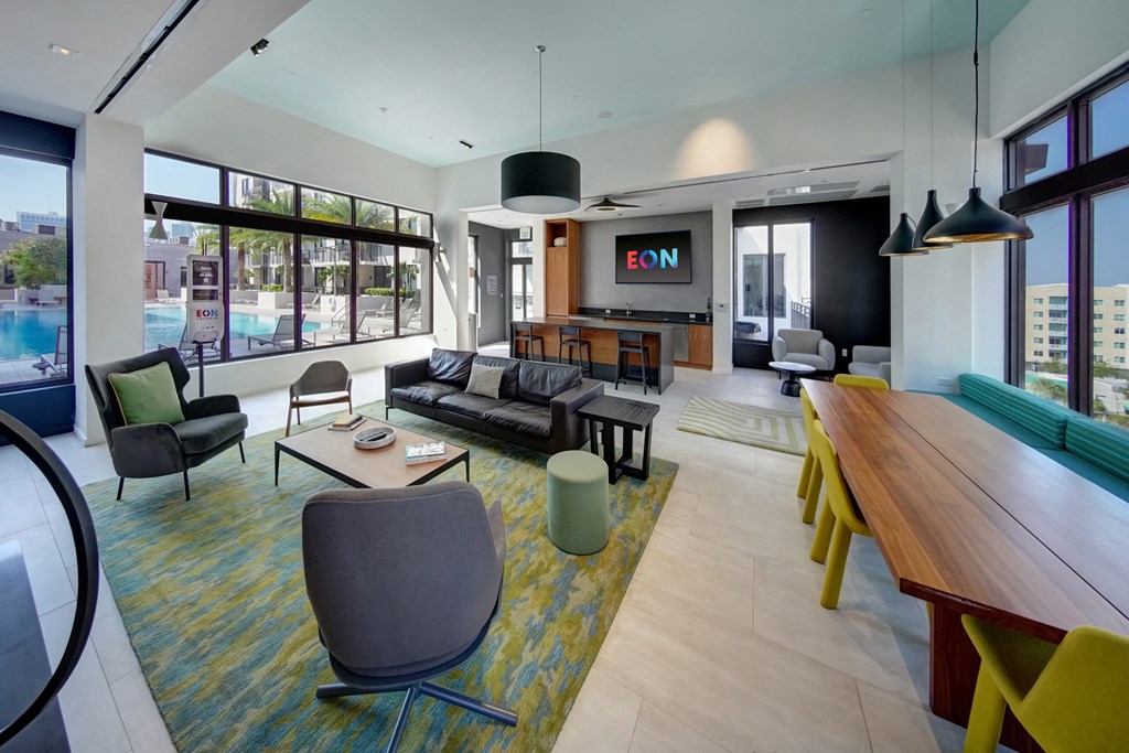 a living room and dining room with a table and chairs