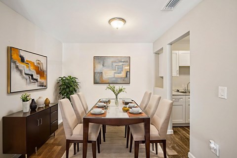 A dining room with a wooden table and chairs.