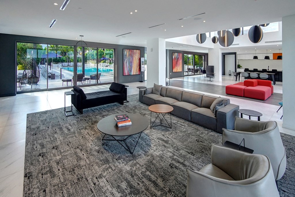 a living room with couches and chairs and a rug