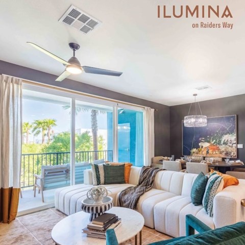 A living room with a white couch and a ceiling fan.