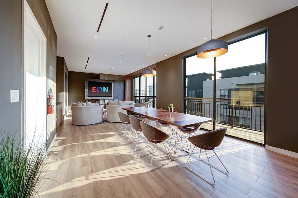 a dining room with a table and chairs and a large window