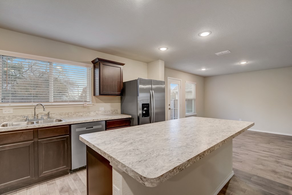 an expansive kitchen with granite countertops and stainless steel appliances