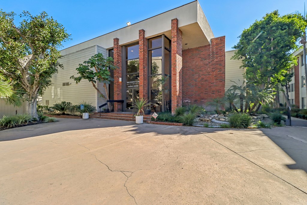 A modern building with a large front door and a brick facade.
