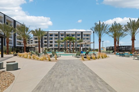 A large building with a pool in front of it.