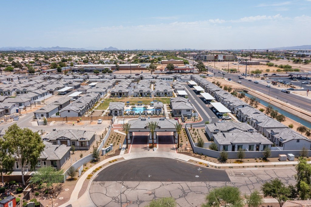 A large housing development with a central courtyard and a road running through it.