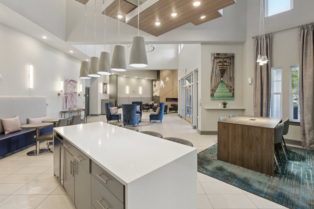 A modern kitchen with a white countertop and a blue bench.
