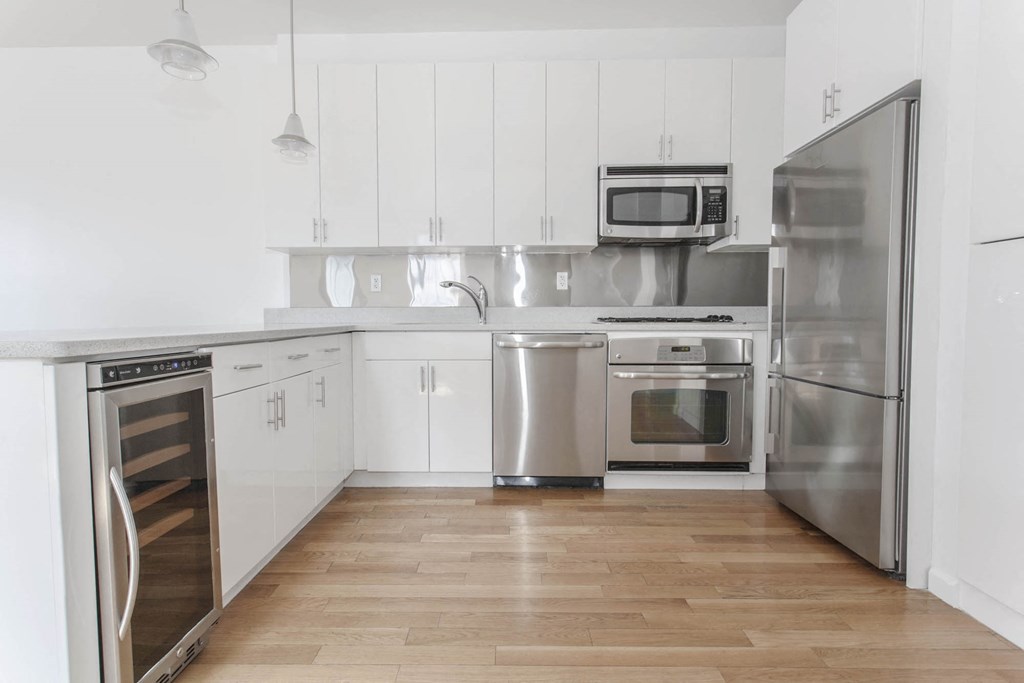 a kitchen with stainless steel appliances and white cabinets