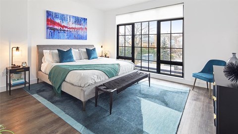 Light filled bedroom with floor to ceiling windows and modern furnishings