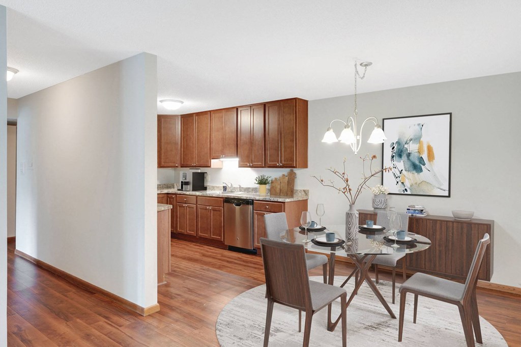 Laurel West End Apartments in Golden Valley, MN photo of a dining area with a table and chairs and a kitchen in the background