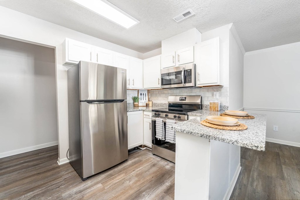 a kitchen with stainless steel appliances and a counter top