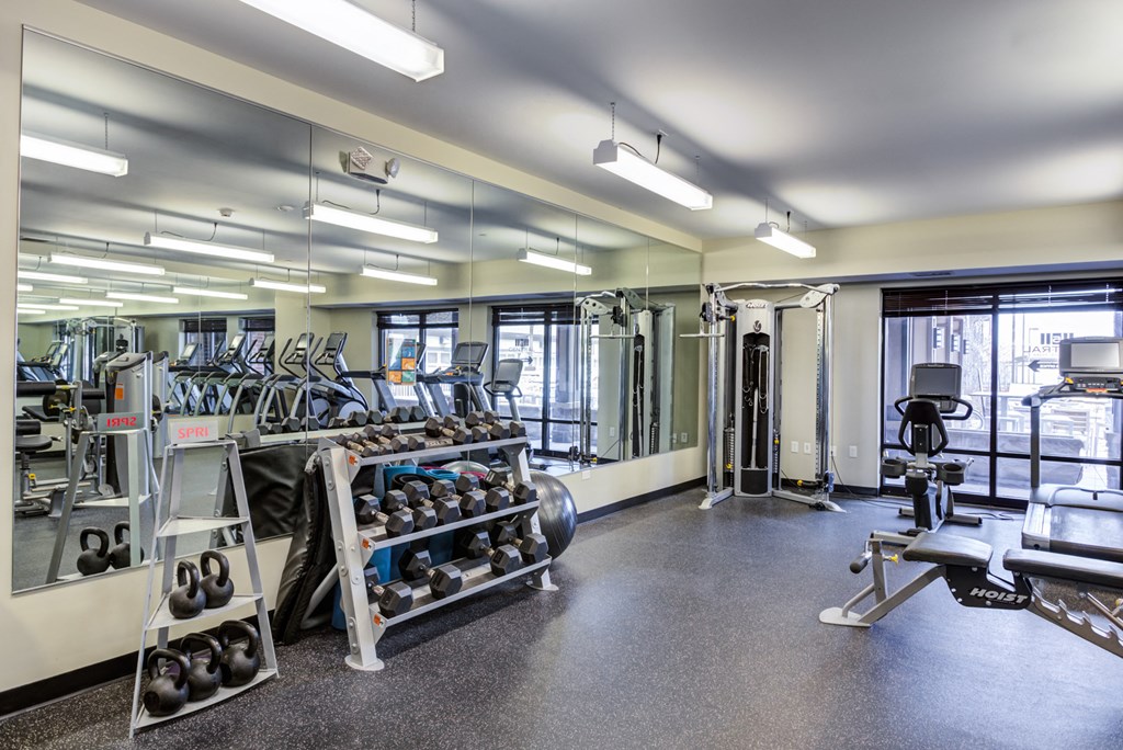 a fitness room with weights and other gym equipment
