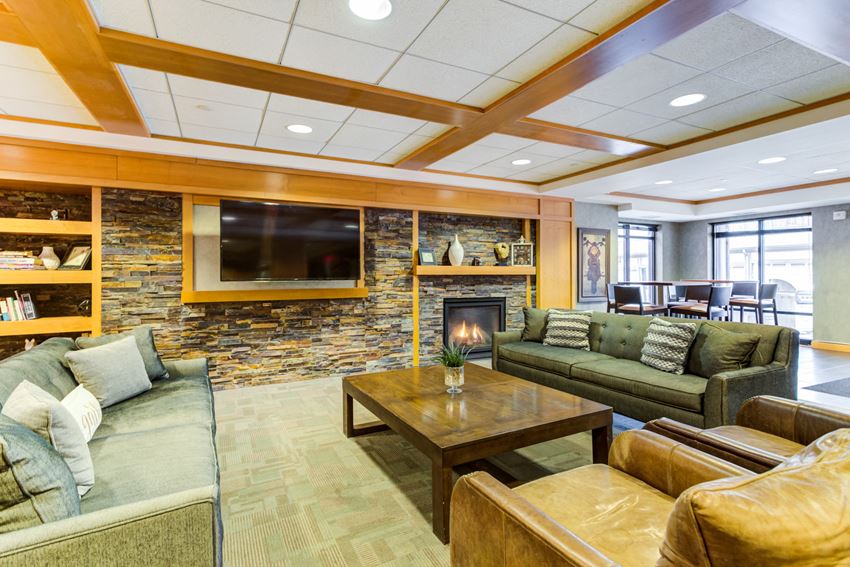 a living room with couches a coffee table and a fireplace