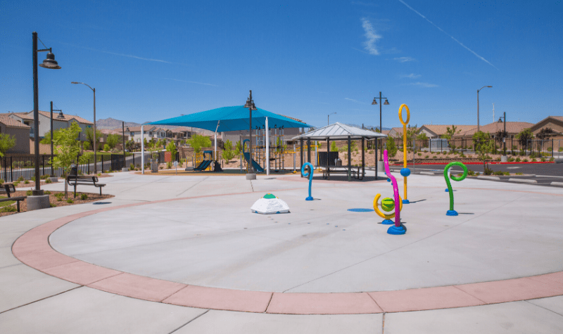 a playground with colorful toys and a blue tent