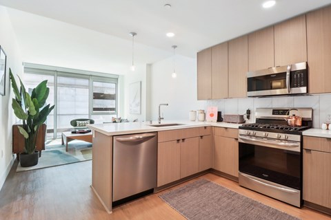 A modern kitchen with wooden cabinets and stainless steel appliances.