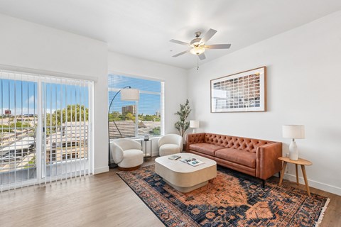 Stylish apartment living room with large windows and contemporary furnishings at Prosper 150