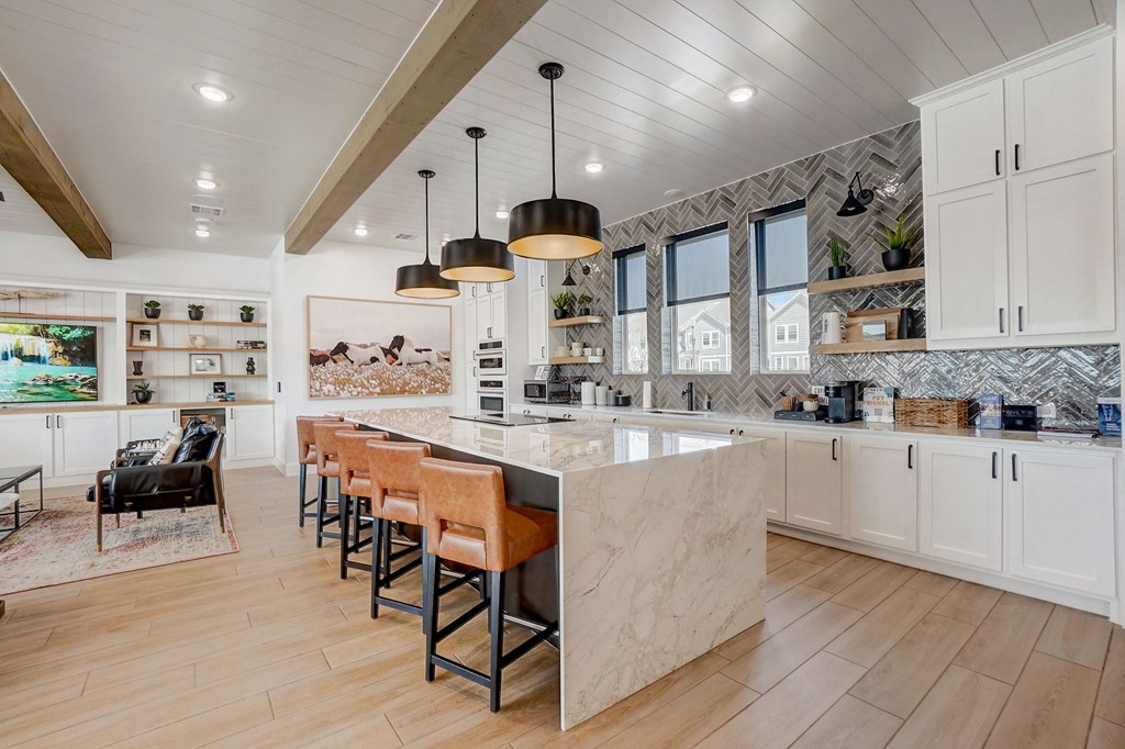a large kitchen with a marble counter top and a dining area