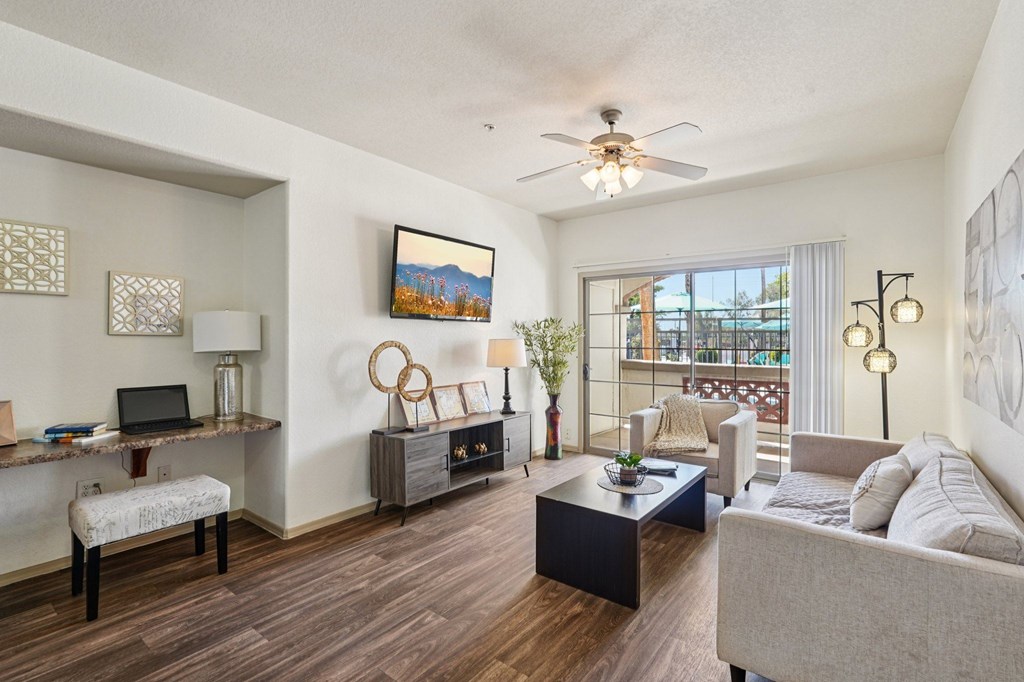 A living room with a couch, chair, and a painting on the wall.