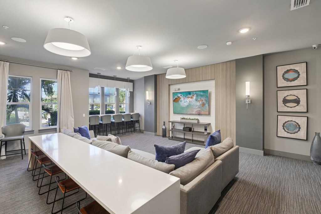 Media room with large screen, comfortable seating, and ambient lighting at Lotus at Starkey Ranch in Odessa, Florida.