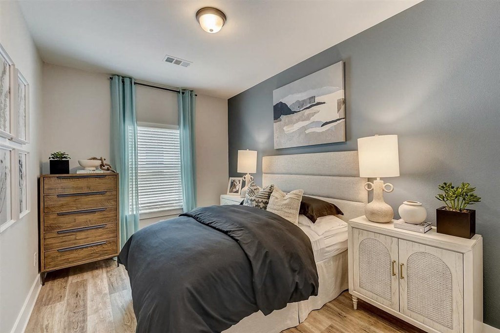 a bedroom with a bed and dresser