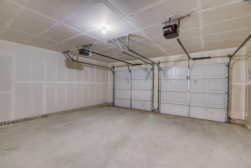 the inside of a garage with two white doors