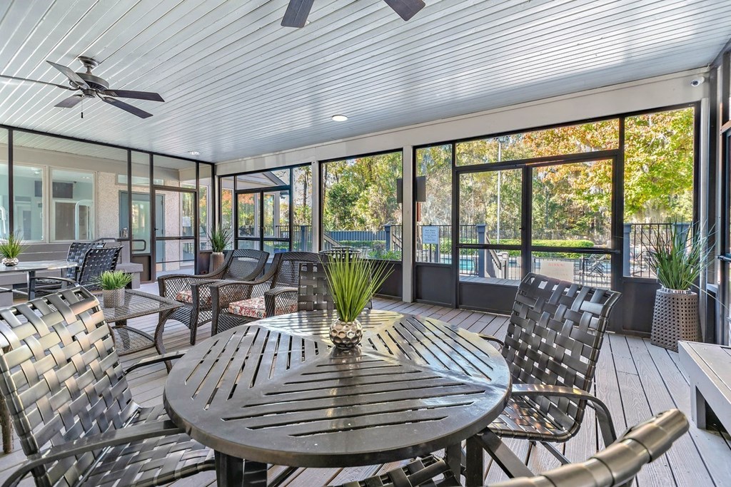 Greentree Apartments in Savannah, GA photo of a screened in porch with a table and chairs