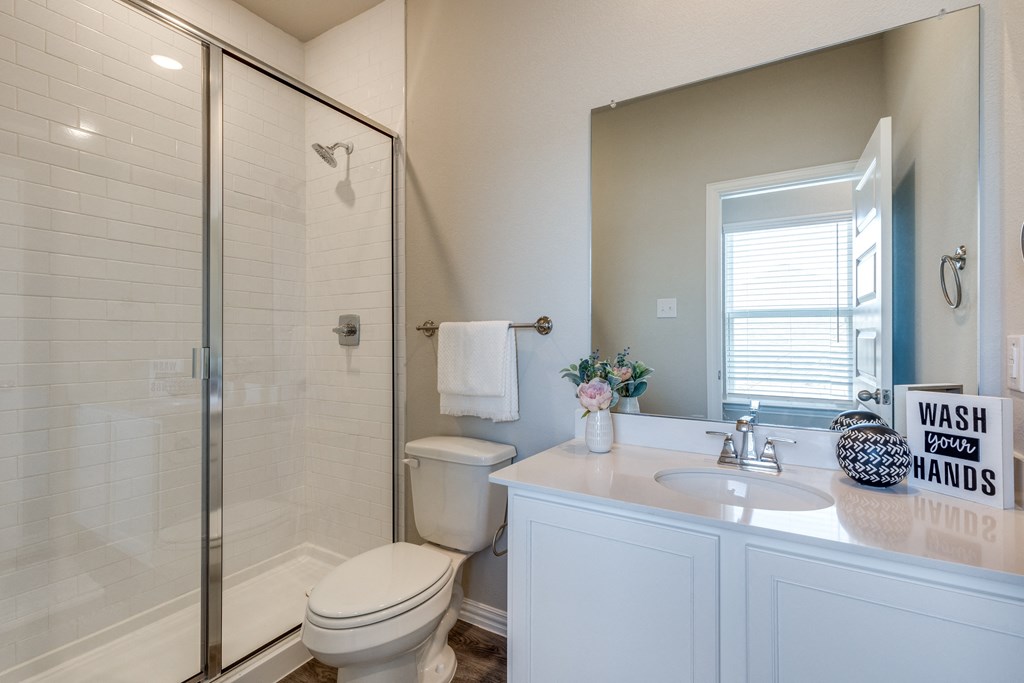 a bathroom with a shower toilet and sink