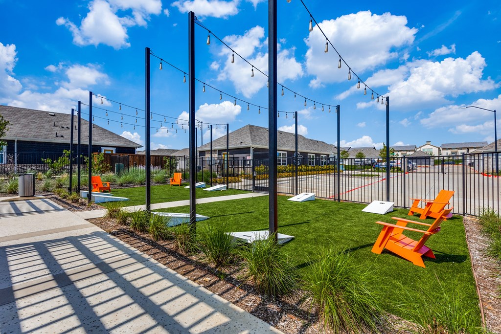 a park with orange benches in front of a fence